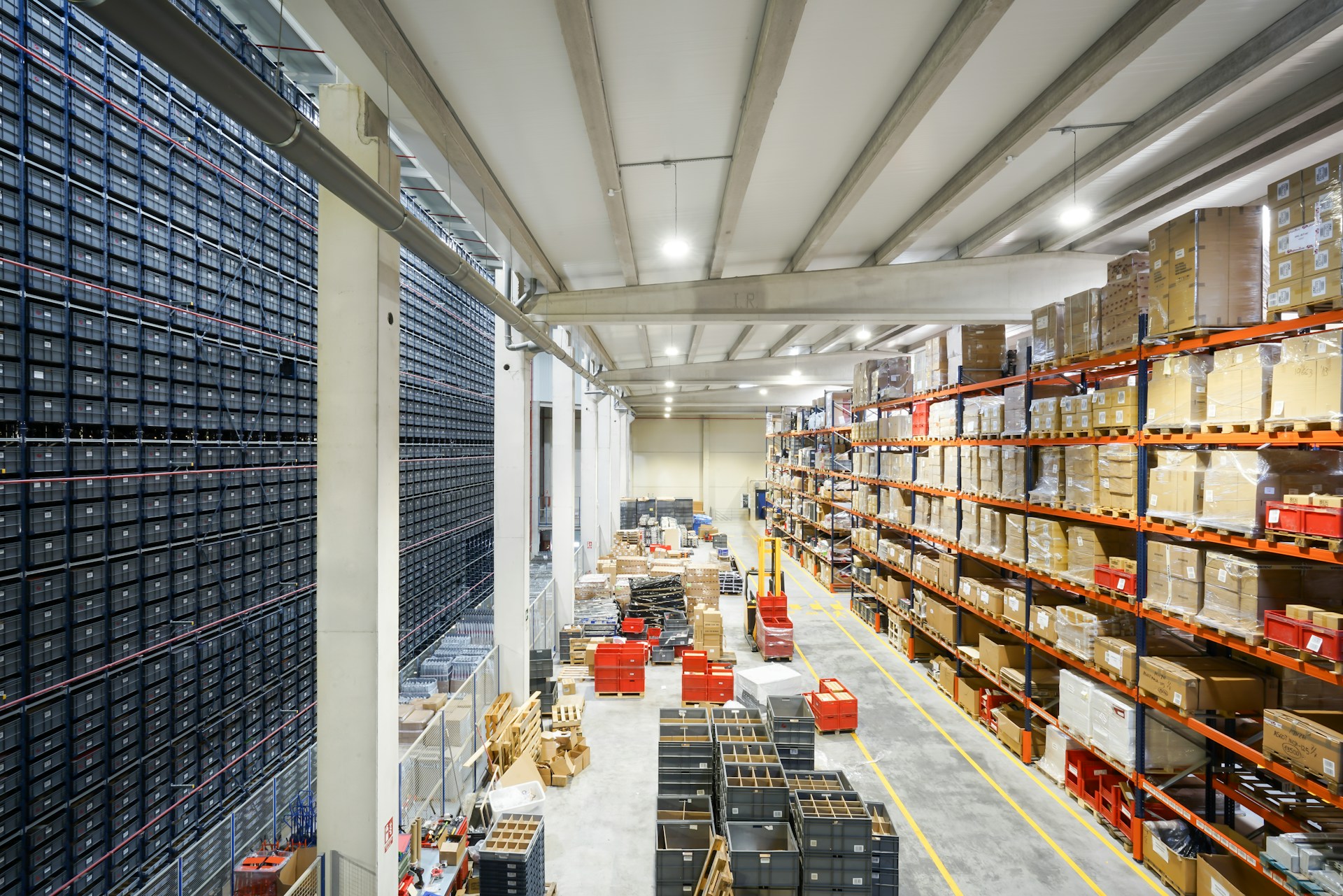 Interior of a large modern warehouse with high racking, boxes and inventory aisles
